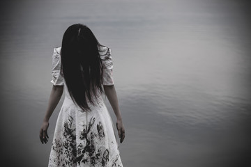 Portrait of asian woman make up ghost face at the swamp,Horror scene,Scary background,Halloween...