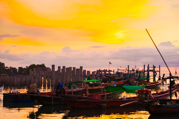 Fototapeta premium Silhouette seascape sunset wooden boat on sea shore