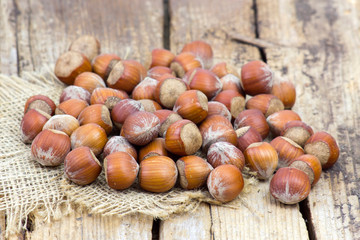 hazelnuts on old wooden background