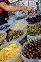 Buckets full of olives , pickles and baby corn