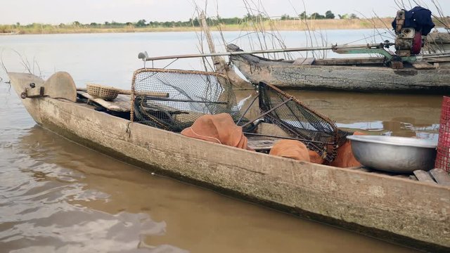 Inside a dugout canoe fishing equipments for harvest clams ( close up)