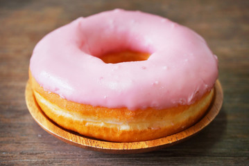 Donut with strawberry cream on the table