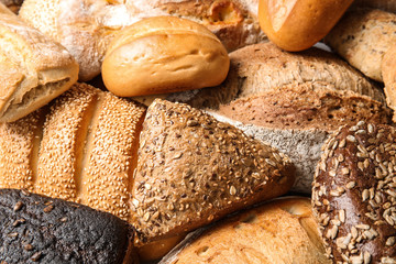 Different kinds of fresh bread as background, closeup