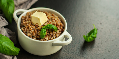 buckwheat porridge and a piece of butter (delicious food) homemade dish. food background. top
