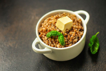buckwheat porridge and a piece of butter (delicious food) homemade dish. food background. top