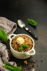 buckwheat porridge and a piece of butter (delicious food) homemade dish. food background. top