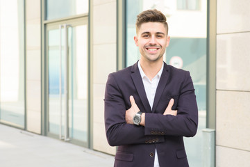 Portrait of successful businessman open in modern city near business center