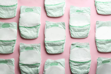 Flat lay composition with diapers on color background. Baby accessories