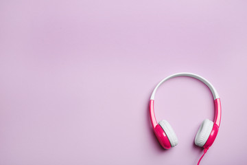 Stylish headphones on color background, top view. Space for text