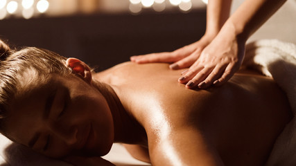 Body care. Masseur Doing Massage On Woman Back