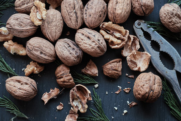 Open and closed walnuts with nutcrackers