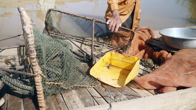 Inside a dugout canoe fishing equipments for harvest clams ( close up)