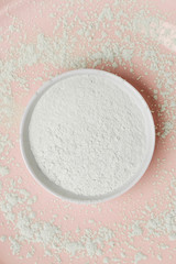 Top view of white cosmetic clay powder in a bowl
