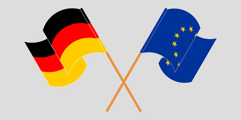 Crossed and waving flags of the EU and Germany