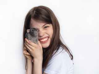 funny girl holding domestic rat in hands, friendship of children and animals, concept