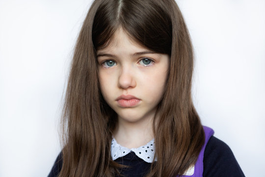 portrait of a sad crying girl in school uniform, closeup on white background