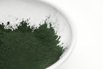 Greens powder in a bowl. Greens powders are dietary supplements designed to help you reach your daily recommended vegetable intake.