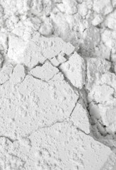White cosmetic clay powder textured background, close up