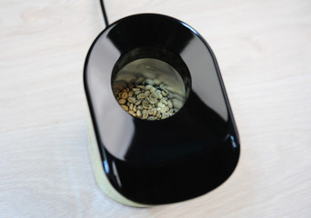 Home-made roast of green coffee beans in popcorn pop box. Top view