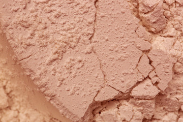 Pink cosmetic clay powder textured background, close up,