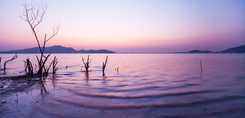 A tranquil lake at sunset.