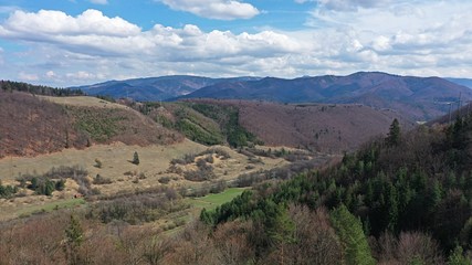 Fototapeta premium Aerial view of spring uplands in central Slovakia, during slightly cloudy afternoon.