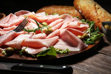 Sliced ham on wooden background. Fresh prosciutto. Pork ham proscuitto sliced.