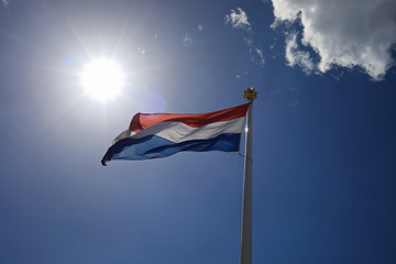Flag of Netherlands (Holland) on the flagpole against the sky