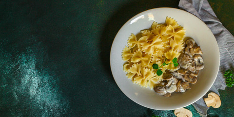 pasta farfalle with julienne mushrooms (fresh dish). food background. top