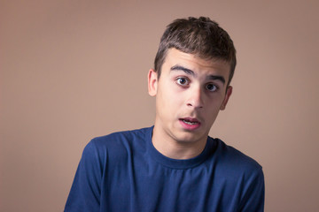 Fototapeta premium Closeup portrait of young man feeling surprised, scared.