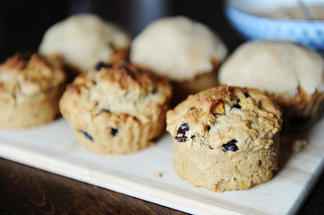 Freshly baked muffins on a wooden board. Glazing process
