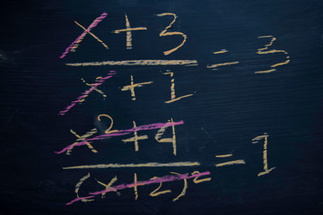 Close up math formulas written on a blackboard. Education concept