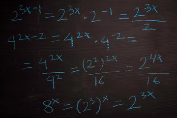 Close up math formulas written on a blackboard. Education concept