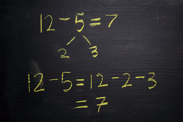 Close up math formulas written on a blackboard. Education concept