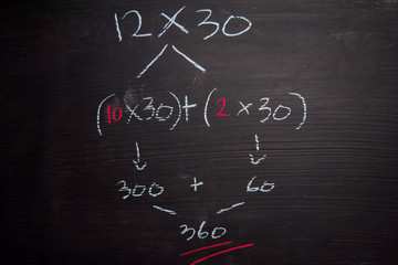 Close up math formulas written on a blackboard. Education concept