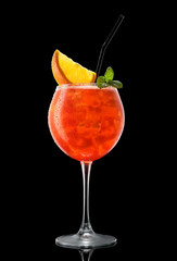 Big round wine glass with fresh cold red cocktail isolated on black background