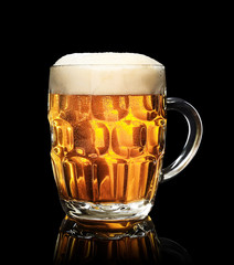mug of beer on on black background