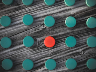 Image of different colored plastic caps on wooden background
