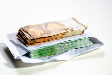 Euro banknotes put in an envelope. A large amount of money with a shallow depth of field.