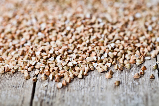 Organic green dry buckwheat seads closeup on rustic wooden background.