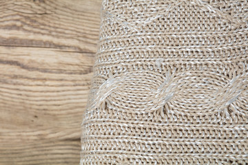 Pile of knitted winter clothes on wooden background, sweaters, knitwear, space for text