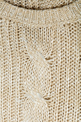 Pile of knitted winter clothes on wooden background, sweaters, knitwear, space for text