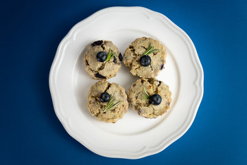 Fresh Baked Raspberry and Blueberry oatmeal wheat Scones set on Blue Background.