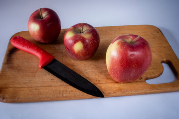 red apples on a wooden board