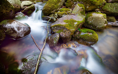 Flowing water over tumbled rocks in a stream