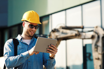 Construction engineer using digital tablet on the construction site