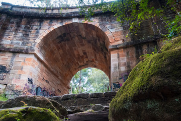 Viaduct bridge with trees and a small creek.