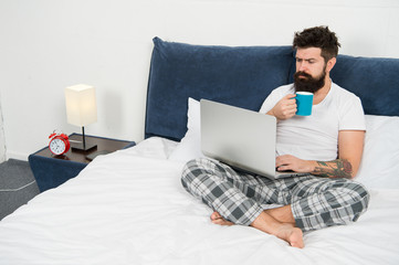 Sleeping at working place. asleep and awake. energy and tiredness. businessman with computer. bearded man hipster work on laptop. brutal sleepy man in bedroom. mature male drink coffee