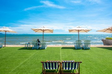 lounge chairs with sun umbrella on a beach