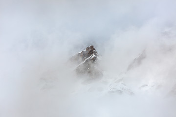 Alps peaks are covered by clouds.